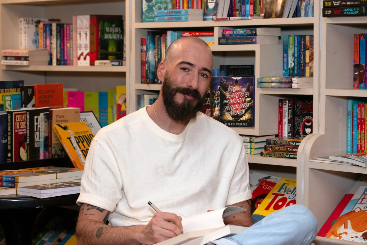 Portrait of a bearded man in a bookshop