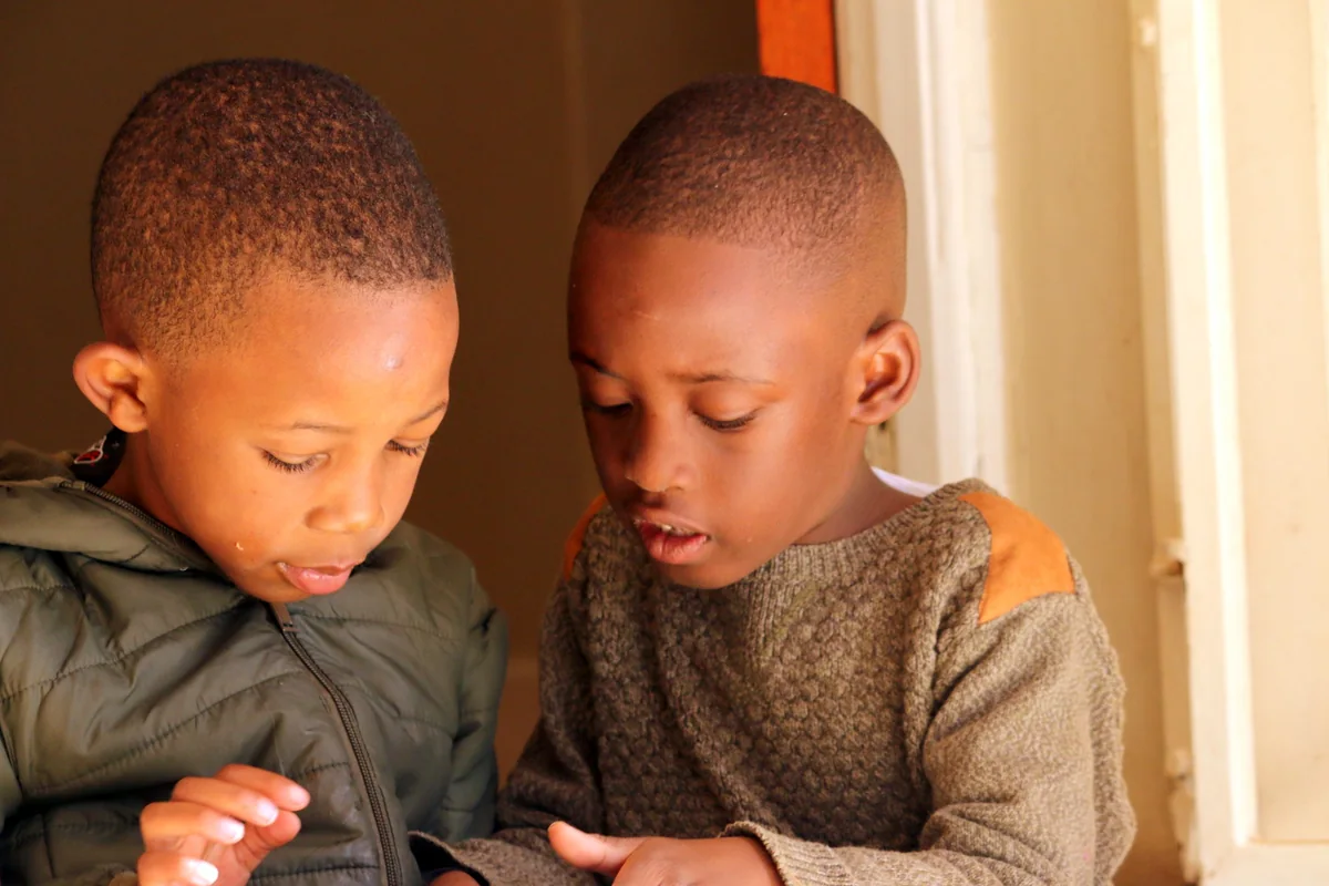 Two boys concentrating on an activity